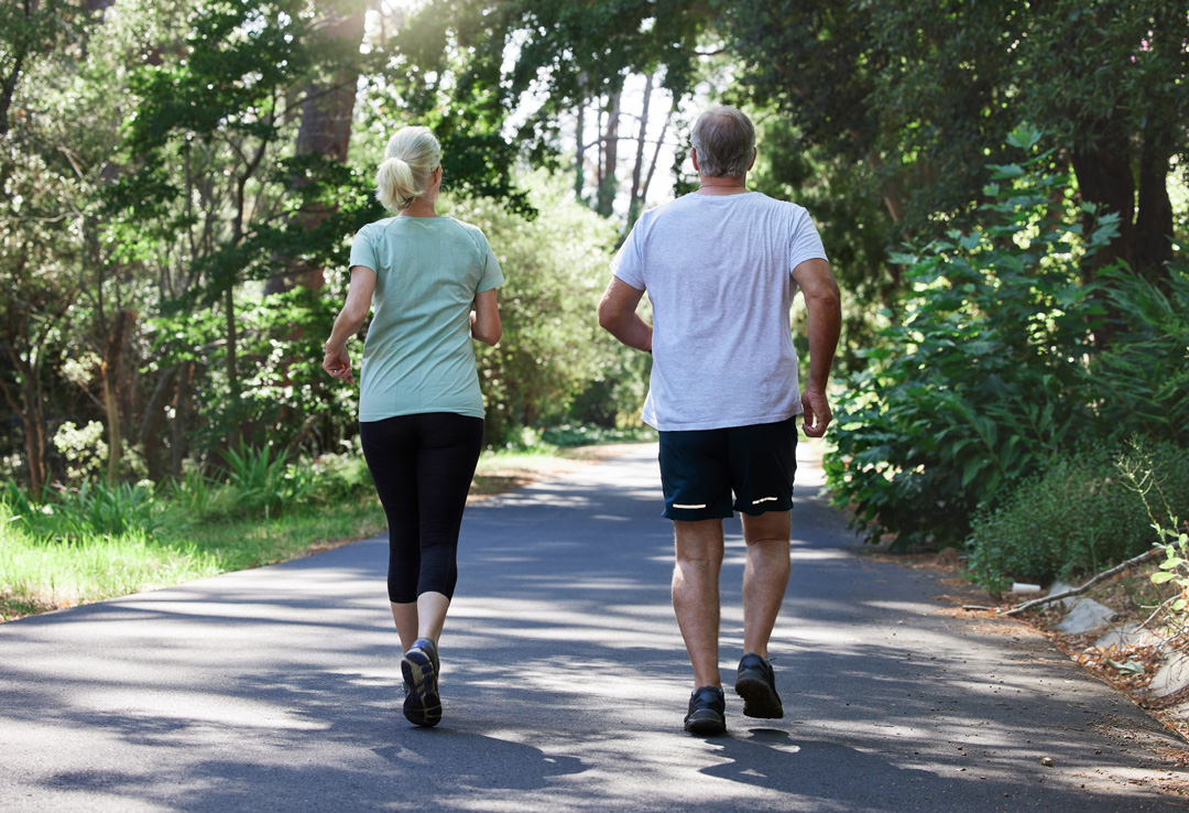 Senior couple, running and back outdoor for exercise, workout and training on road for fitness
