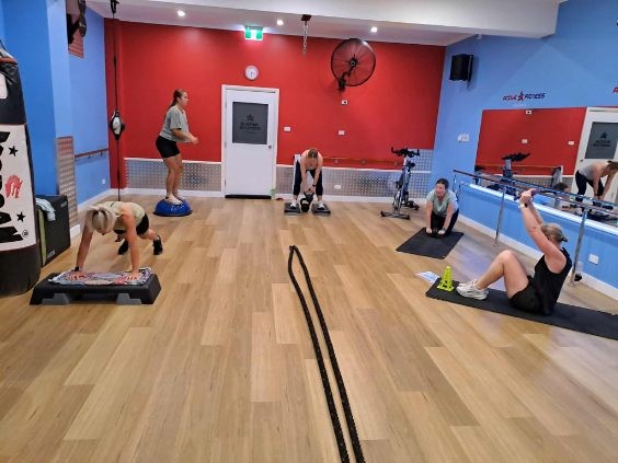 A group of women engage in a multi-station circuit workout at Active Fitness Medowie