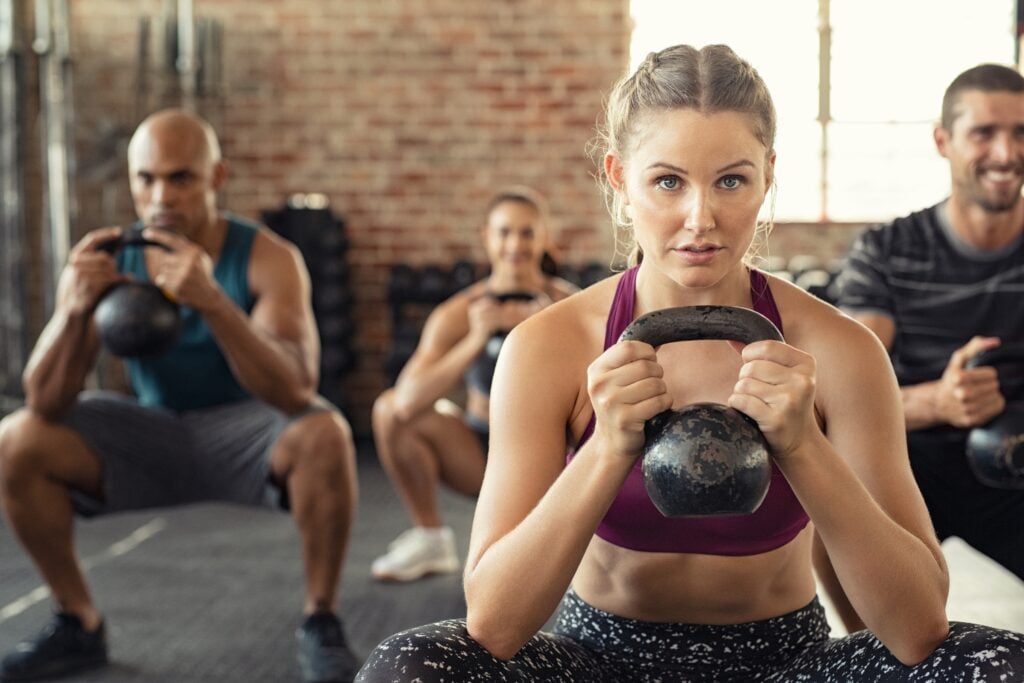 Person lifting weights during traditional strength workout