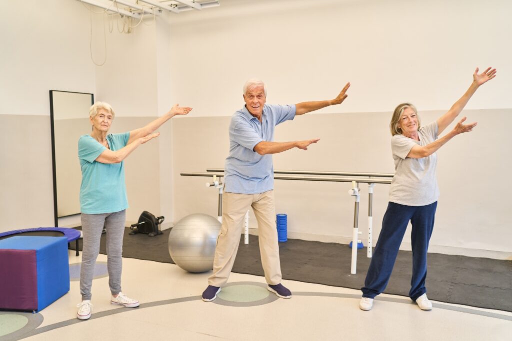 Local trainer helping a client with big movement exercises for Parkinsons at Medowie gym.