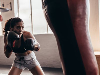 Boxer Training with Heavy Bag in an Authentic Gym Setting