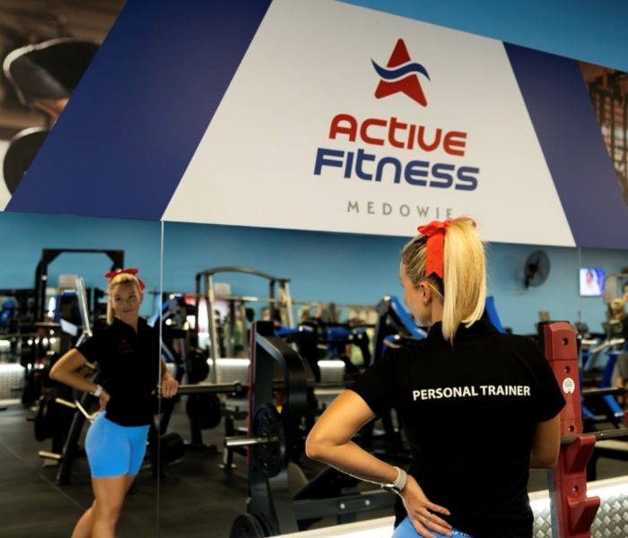 Personal trainer at Active Fitness Medowie facing mirror in fully equipped gym facility
