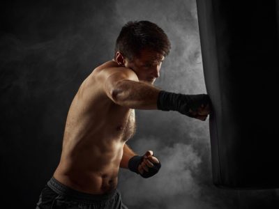 Male Boxer Training with a Punching Bag