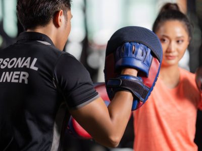 Personal Trainer Holding Focus Mitts During Boxing Class